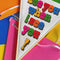 model showcasing cream pennant luggage tag with colorful 'see you when i see you!' front and pink, yellow and green trim