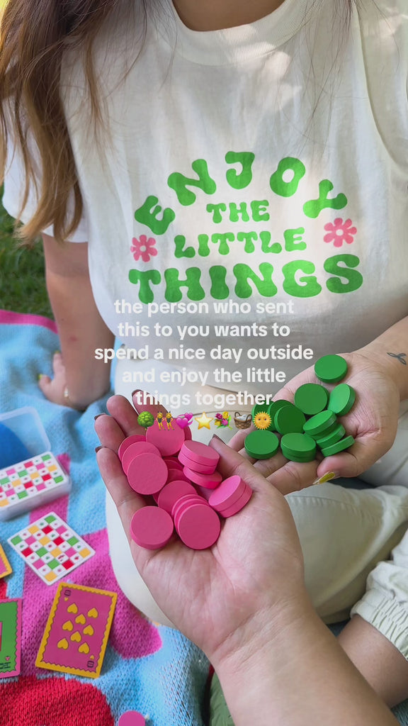 model playing pink and green four in a row board game