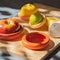 set of five terracotta toned food huggers on various fruits