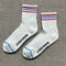 pair of white socks with red and blue stripe accents